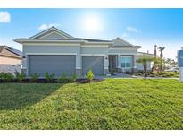 Beautiful house exterior with two-car garage and landscaped yard at 10386 Calumet Blvd, Port Charlotte, FL 33981