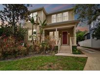 Two-story house with red door, front porch, and landscaped yard at 3104 W Fielder St, Tampa, FL 33611