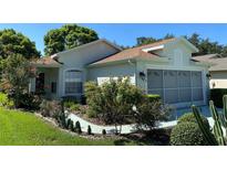 One-story house with landscaped yard at 11230 Heathrow Ave, Spring Hill, FL 34609