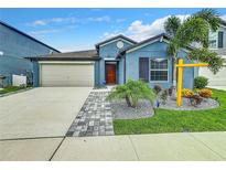 Curb appeal abounds in this charming one-story home featuring a two-car garage and well-manicured landscaping at 13336 Great Plains Dr, Riverview, FL 33579
