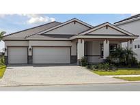 Charming single-story home featuring a spacious three-car garage and well-manicured landscaping at 10324 Longmeadow Ave, Parrish, FL 34219