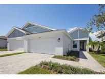 Two-story home with three-car garage and a walkway at 12390 Oak Hill Way, Parrish, FL 34219