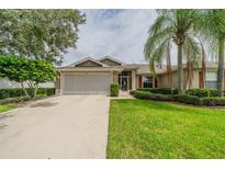 Single-story home with attached garage and well-manicured lawn at 1120 Corinth Greens Dr # 25, Sun City Center, FL 33573