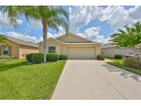 Single-Gathering home with attached garage and manicured lawn at 16903 Peaceful Valley Dr, Wimauma, FL 33598
