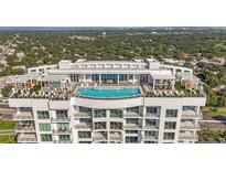 Aerial view of a luxury highrise building with rooftop pool and city views at 2910 W Barcelona St # 903, Tampa, FL 33629