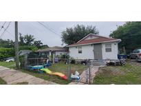 Cute bungalow style home with a fenced yard and playset at 8003 N Klondyke St, Tampa, FL 33604