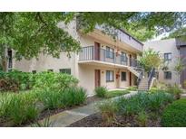 Two story building exterior with lush landscaping at 11702 Raintree Village Blvd # A, Temple Terrace, FL 33617