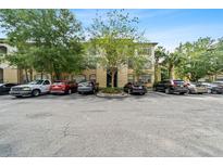 Exterior view of condo building with parking lot and landscaping at 17104 Carrington Park Dr # 528, Tampa, FL 33647