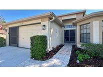 Charming single-story home with a well-maintained front yard, two car garage, and tiled walkway to the front door at 11416 Billingham Blvd, Spring Hill, FL 34609