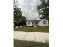Charming house with white exterior, landscaping, and walkway at 5238 16Th St, Zephyrhills, FL 33542