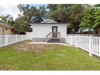 Small cottage with white exterior and fenced yard at 4622 Paloverde Dr, New Port Richey, FL 34652