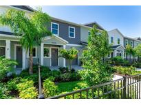 New construction townhome featuring modern elevation with gray tones and lush landscaping at 5530 N 9Th St # 3, Tampa, FL 33604