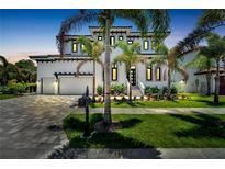 Two story house with a large driveway and landscaping at 517 Treviso Dr, Apollo Beach, FL 33572