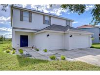 Two-story house with a two car garage and landscaped yard at 20131 Nob Oak Ave, Tampa, FL 33647