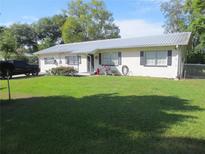 Ranch style home with metal roof, shutters, and large yard at 10311 Us Highway 98, Dade City, FL 33525
