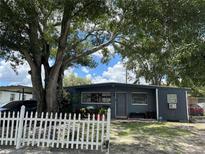 Ranch style home with a white picket fence at 2027 Warrington Way, Tampa, FL 33619