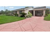 Single-story home with a carport and landscaped yard at 329 Grayston Pl # 112, Sun City Center, FL 33573