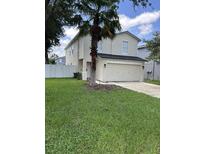 Two-story house with a two-car garage and a well-manicured lawn at 17350 Garden Heath Ct, Land O Lakes, FL 34638