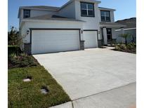Inviting two-story home with a three-car garage and a well-manicured lawn at 18320 Fattoria Ter, Lakewood Ranch, FL 34211