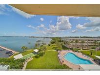 Aerial view of waterfront property with pool and lush landscaping at 100 Bluff View Dr # 404A, Belleair Bluffs, FL 33770