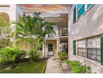 Exterior view of condo building showcasing entrance and landscaping at 4315 Aegean Dr # 116C, Tampa, FL 33611