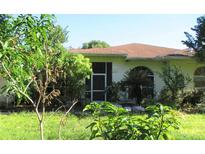 House exterior with lush landscaping and brown roof at 33255 State Road 70 E, Myakka City, FL 34251