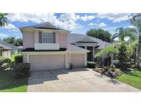 Two-story house with a two-car garage and landscaped yard at 19334 Autumn Woods Ave, Tampa, FL 33647