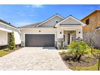 Beautiful single-story home featuring a paved driveway, a gray two-car garage, and well-manicured landscaping at 652 Allora Ave, Nokomis, FL 34275