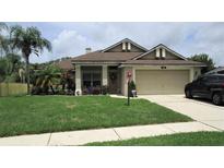Single story home with attached garage and manicured lawn at 3464 Silverstone Ct, Plant City, FL 33566