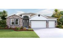 Two-story house with stone accents, three-car garage, and landscaped yard at 18316 Fattoria Ter, Lakewood Ranch, FL 34211