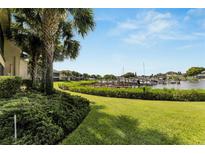Landscaped backyard with a view of boats docked at a marina at 636 Yardarm Dr # 636, Apollo Beach, FL 33572