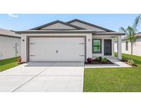 One story home with attached garage, landscaping and driveway at 29508 Fedora Cir, Brooksville, FL 34602