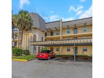 Exterior view of a condo building with parking at 8699 Bardmoor Blvd # 304, Seminole, FL 33777