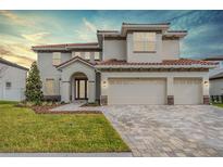 Beautiful two-story home with a three-car garage and a paved driveway at 7134 Heather Sound Loop, Wesley Chapel, FL 33545