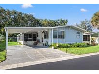 Charming single-wide manufactured home with carport at 34050 Estates Ln, Wesley Chapel, FL 33543