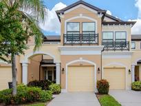 Two-story townhome with a two-car garage and attractive landscaping at 9107 Carolina Wren Dr, Tampa, FL 33626