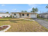 Charming single story home with a well-maintained front yard and a one car garage at 10735 64Th N Ave, Seminole, FL 33772