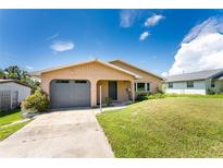 Single story home with grey garage door at 29171 Orva Dr, Punta Gorda, FL 33982