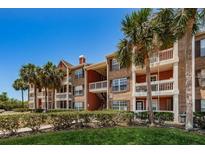 Brick apartment building with lush landscaping and palm trees at 10200 Gandy Blvd # 1116, St Petersburg, FL 33702