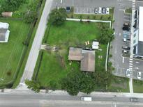 Aerial view of a house and lot situated near a road and other buildings at 11348 Pine St, Riverview, FL 33578