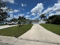 House with a long driveway and a spacious front yard at 2702 Campus Hill Dr, Tampa, FL 33612