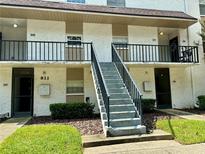 Exterior view of two-story building with stairs and balconies at 811 Russell Ln # 309, Brandon, FL 33510