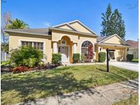 Charming single-story home with a well-maintained lawn and manicured landscaping at 1130 Big Creek Dr, Wesley Chapel, FL 33544