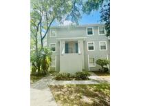 Two-story building exterior with landscaping and walkway at 7156 E Bank Dr # 7156, Tampa, FL 33617