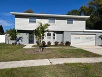 Charming two-story home featuring a well-maintained lawn and an attached two-car garage at 8320 Boxwood Dr, Tampa, FL 33615
