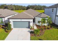 Single-story house with a two-car garage and landscaped yard at 3008 Forest Meadow Ave, Valrico, FL 33594