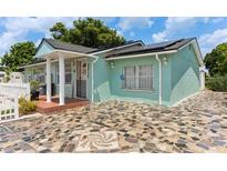Charming light teal home with a stone driveway at 8816 Ascot Ct, Tampa, FL 33634