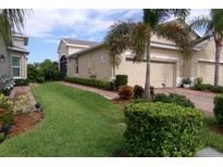 Well-maintained house with a two-car garage and landscaped front yard at 809 Chipper Dr, Sun City Center, FL 33573
