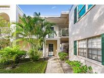 Two-story building with a walkway leading to the unit's entrance at 4335 Aegean Dr # 106A, Tampa, FL 33611