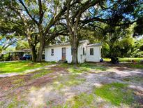 Quaint cottage-style home nestled under large shade trees at 5907 8Th S Ave, Tampa, FL 33619